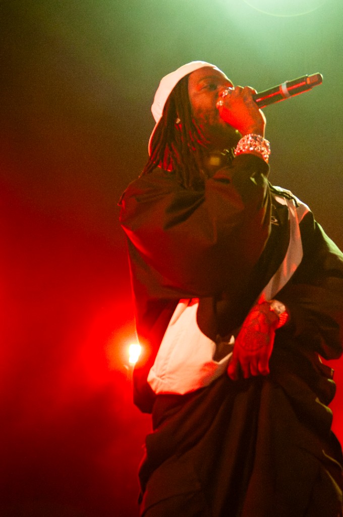 Freddie Dredd locked in under deep red light at the Aztec Theatre, San Antonio